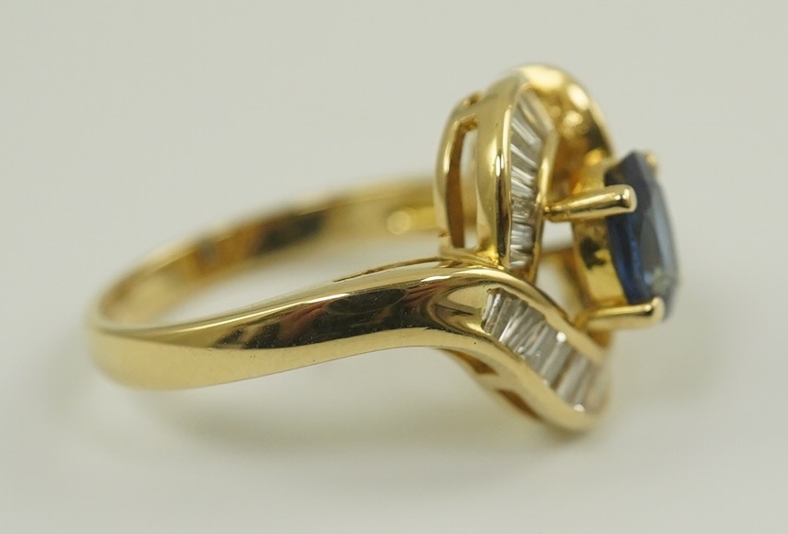 A modern 18k gold, sapphire and diamond cluster set dress ring